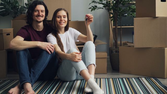 couple holding the keys to their apartment